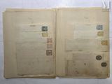 an open book with stamps on it sitting on a table