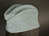 a hat on a mannequin head on a black background