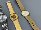 two watches are sitting next to each other on a table