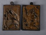 pair of bronze plaques depicting a man and a woman in a landscape