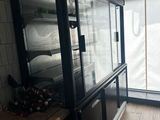 a glass display case in the corner of a room