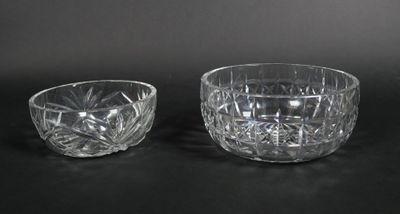 pair of cut glass bowls on a black background