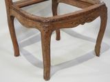 a wooden chair with a glass top on a white background