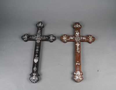 two wooden crosses with white and brown designs on them