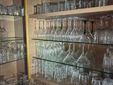 many glasses on the shelves in the room