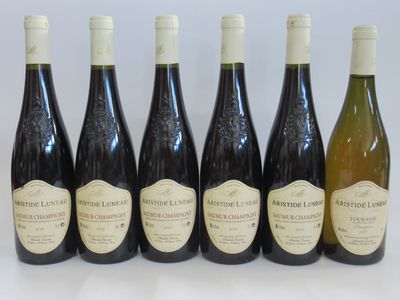 six bottles of wine are lined up in a row on a table
