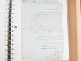 an open book with writing on it sitting on a table