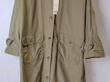 an image of a coat hanging on a hanger on a wall