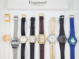 several watches are displayed in a display case on a white surface