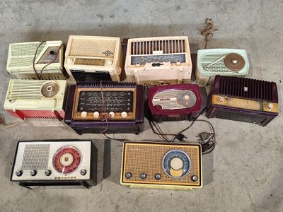a lot of old radio ' s that are on the floor