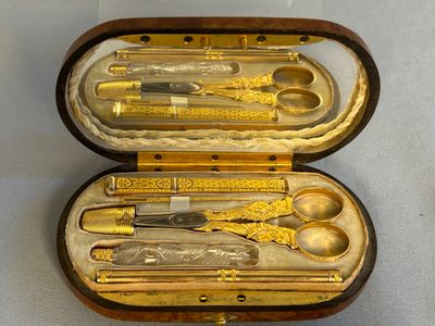 a case that has a set of scissors and spoons inside of it