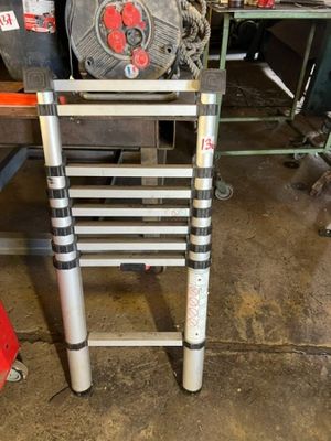 a ladder that is sitting on the floor in the garage