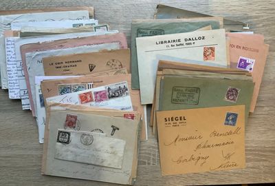 a pile of old letters and envelopes sitting on a table