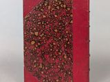 a red book with a red cover and a pattern on it