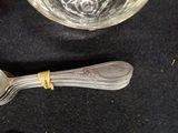 a silver spoon and a glass on a black table