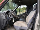 a red truck that has a steering wheel and a seat in it