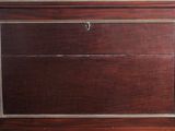 a wooden cabinet with a clock on top of it