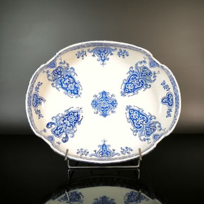a blue and white plate sitting on a black table