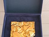 a blue box with a gold tie and a blue box with a gold tie