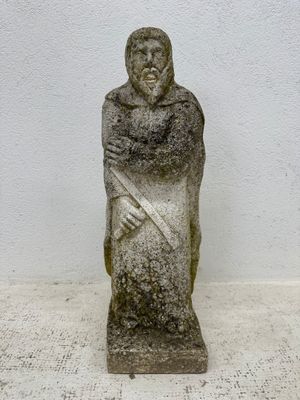 a stone statue of a man with a sword on a table