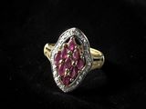 a close up of a pink and white diamond ring on a black background