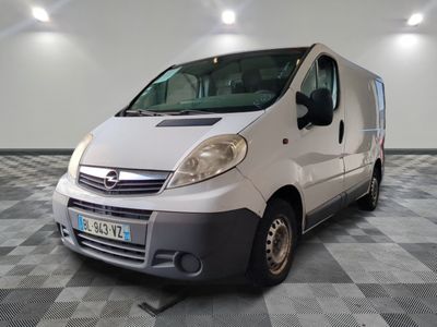 a white van parked in a room with checkered flooring