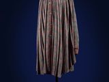a dress on a mannequin stand against a blue background