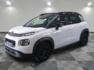 the white citrole is parked in the garage on a checkered floor
