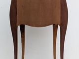 a small wooden table with a marble top on it