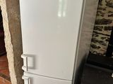 a white refrigerator next to a stove in a room