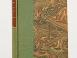 a book with a green cover sitting on top of a table