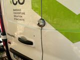 a white van with a green arrow painted on the side of it