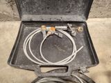 a metal box with a hose and a hose in it