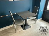a table and two chairs in a room with blue walls