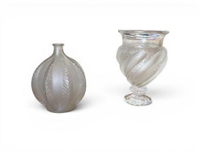 two vases sitting next to each other on a white surface