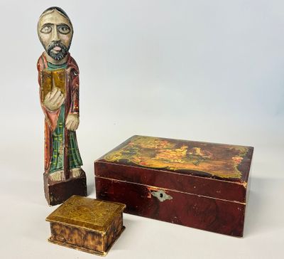 wooden figurine of a man and a box on a white surface