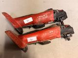 two red tools are sitting on the floor next to each other