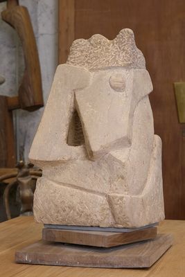une sculpture en pierre posée sur une table en bois dans une pièce