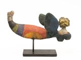 sculpture of a fish on a wooden base with a white background