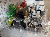bottles and glasses are on a shelf in a store