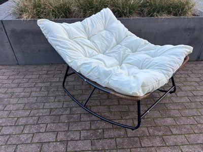 une chaise blanche posée sur un sol en briques