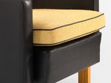 an image of a black and yellow chair with a yellow cushion
