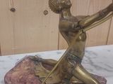 a statue of a woman holding a globe on a marble base