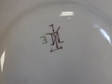 a close up of a plate with a monogram on it