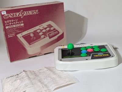 a game controller sitting next to a book on a table