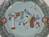 a plate with a picture of people on it
