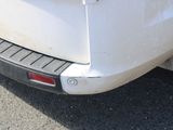 a white car that is parked on the side of the road