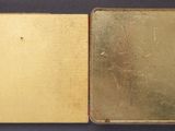 an open book sitting on top of a table next to another book