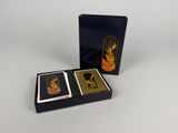 two playing cards in a black box with gold foil on them