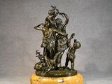 an image of a bronze statue of a woman and two dogs